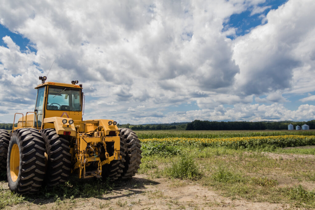 Big yellow tractor, a commercial vehicle in an open Indian field