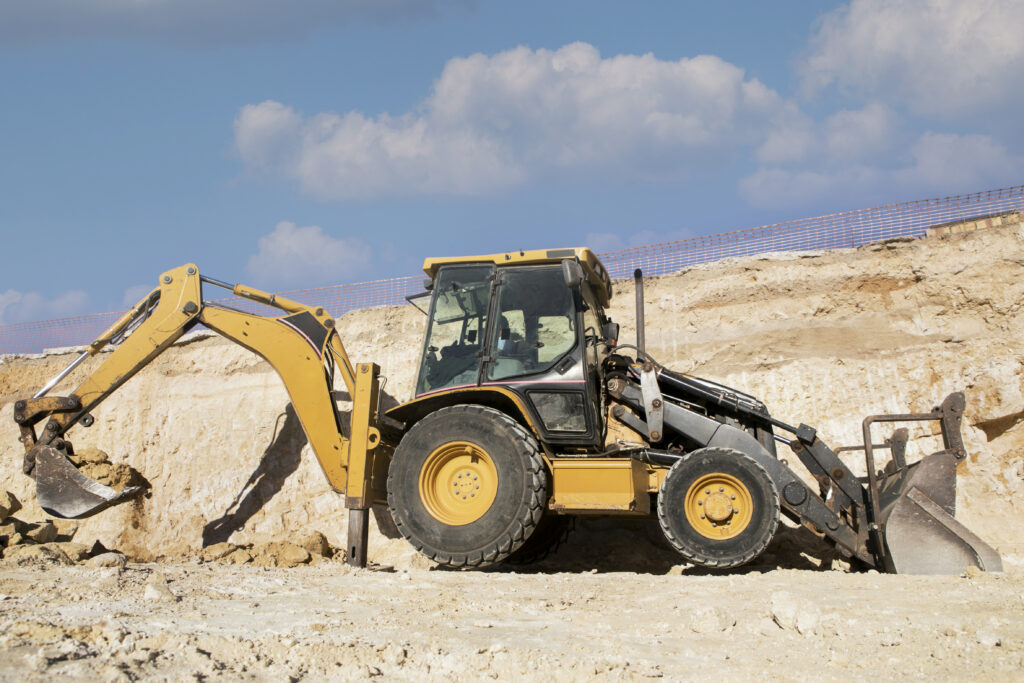 a construction vehicle, excavator digging on a construction site